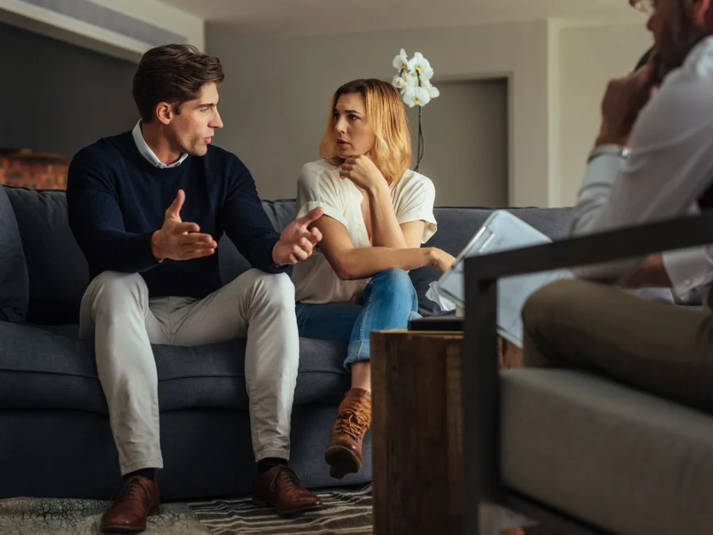 couple arguing during therapy session with psychologists