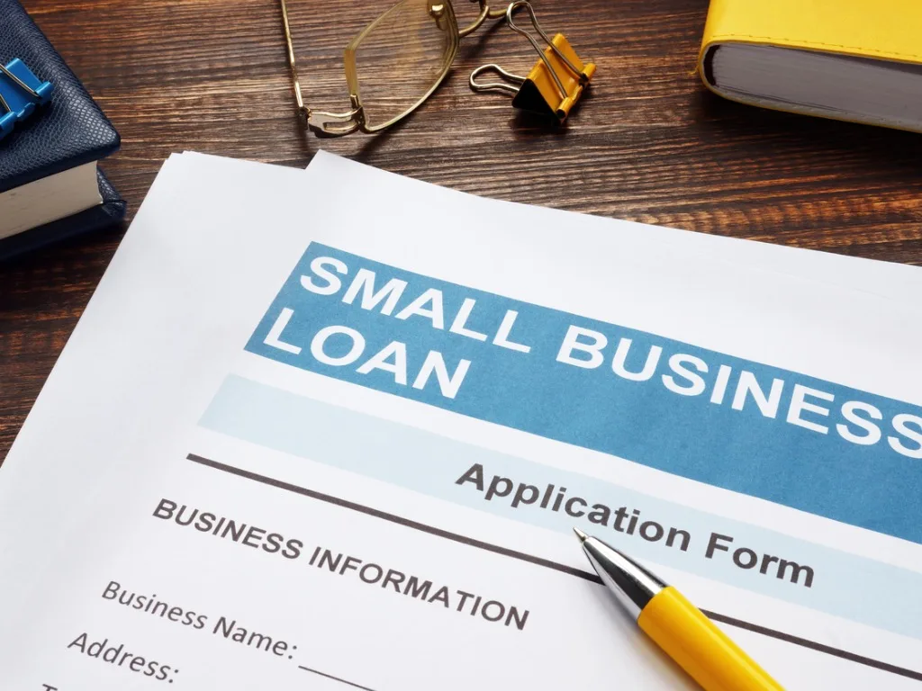 small business loan application on the wooden surface and papers