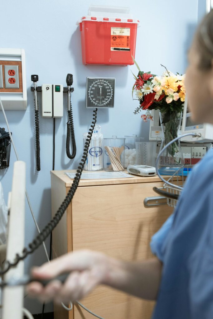 woman taking blood pressure and blood pressure machine on the wall